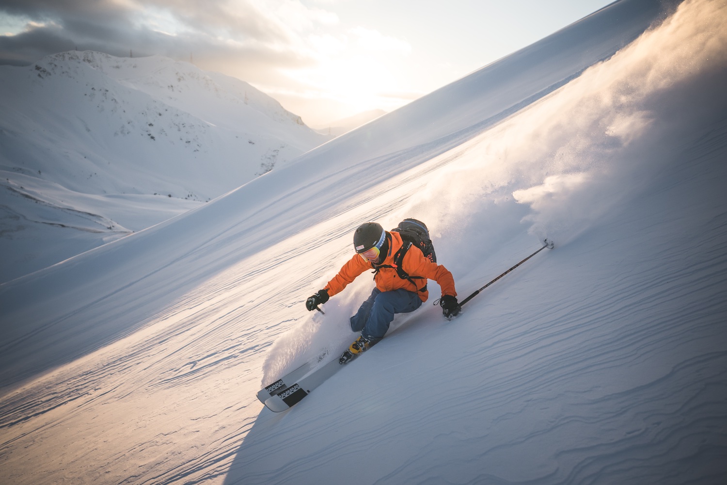 Person freeriding down ski slope creating snow dust cloud, Skicircus Saalbach Hinterglemm Leogang Fieberbrunn