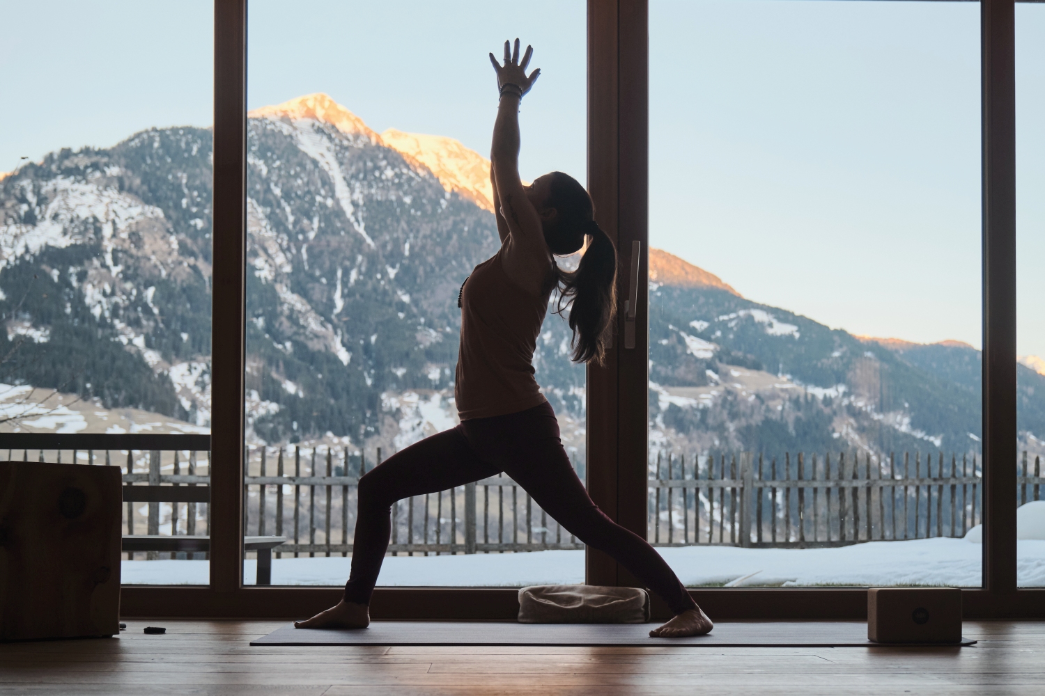 Woman doing yoga with snowy mountain in background