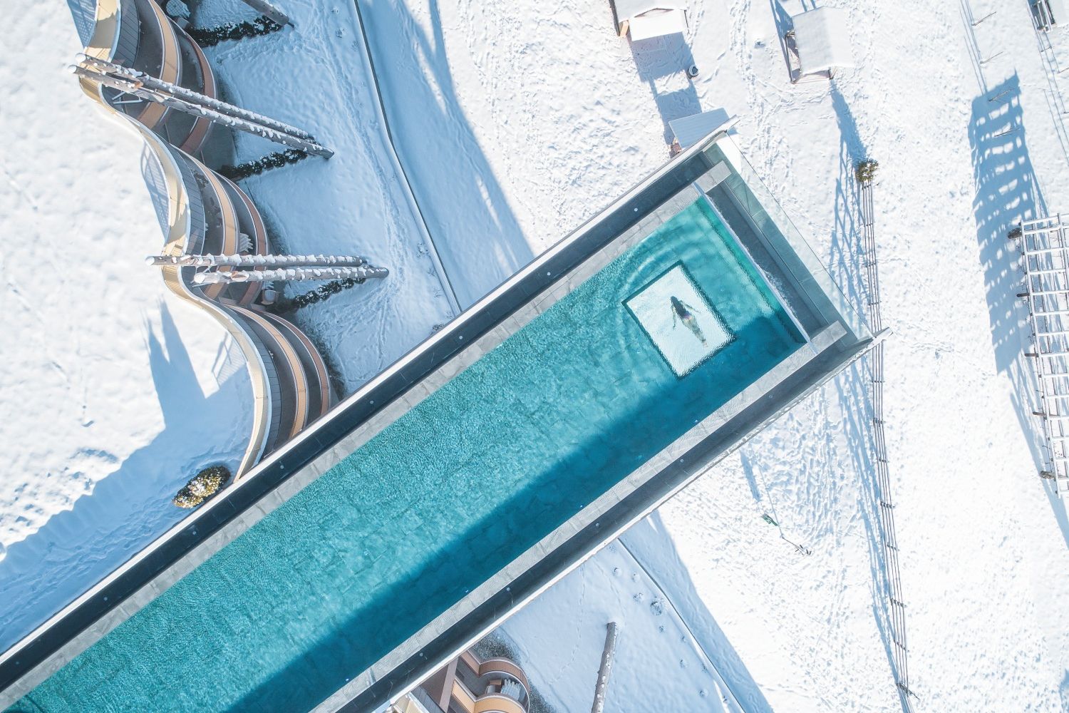 Woman swimming in long Skypool in winter 2022 - Kronzplatz, Italy