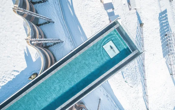 Woman swimming in long Skypool in winter 2022   Kronzplatz Italy Cool lodgings CREDIT Manuel Kottersteger Hotel Hubertus