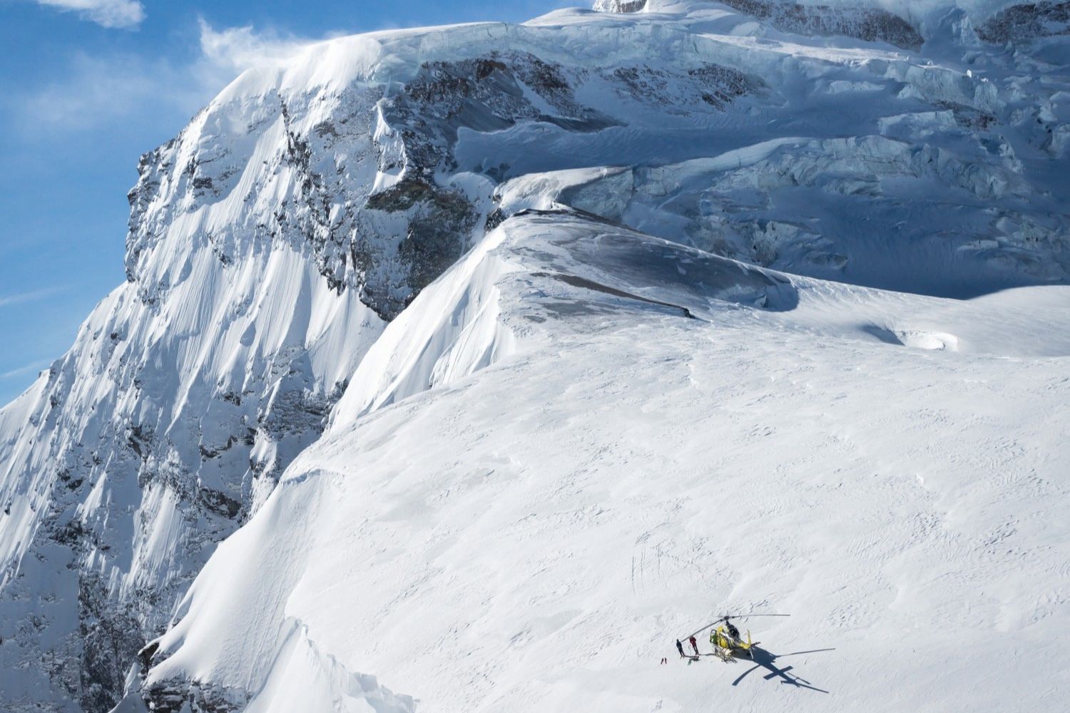 Heliskiing on the edge of a mountain