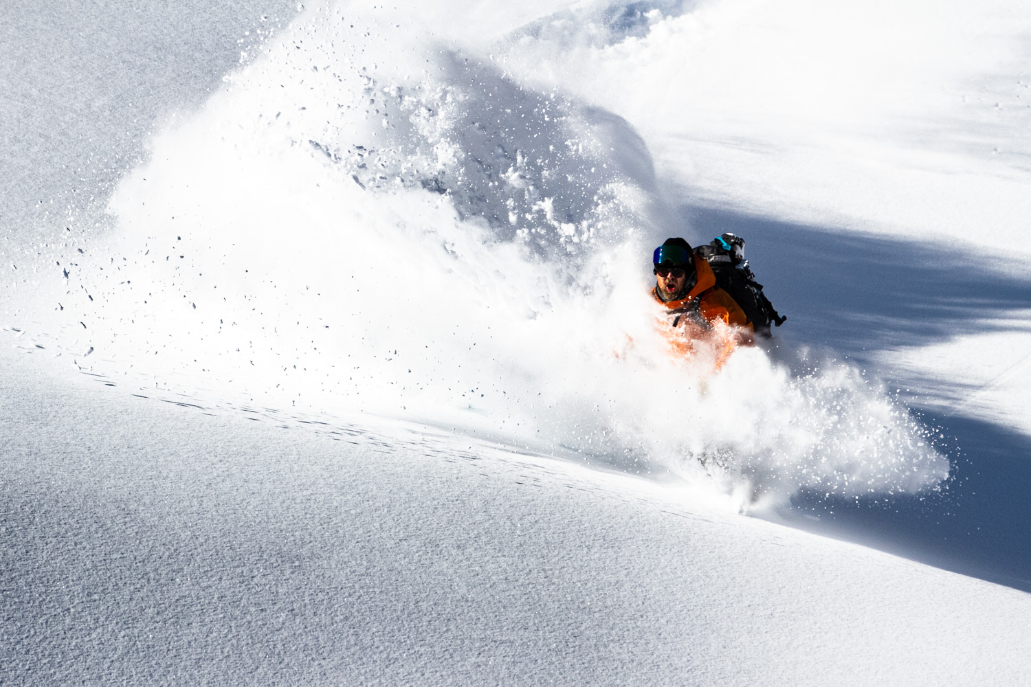 Man coming through large snow dust cloud