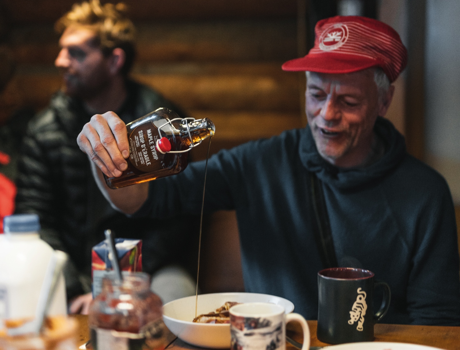 man pouring maple syrup