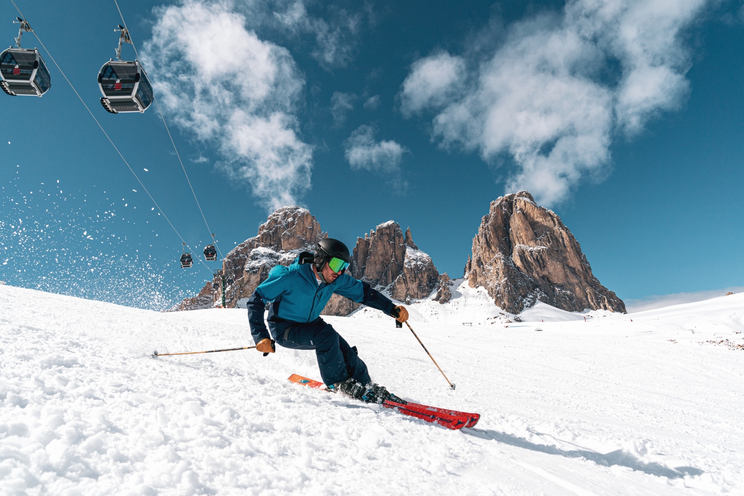 Man skiing down slope, Val di Fassa