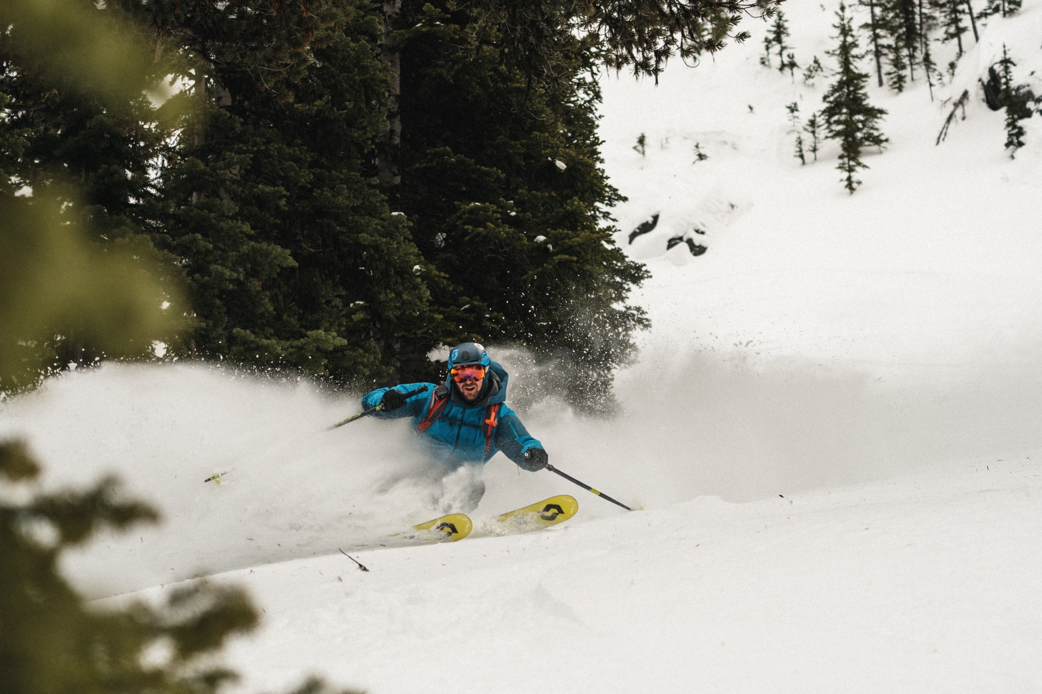 Man skiing by trees