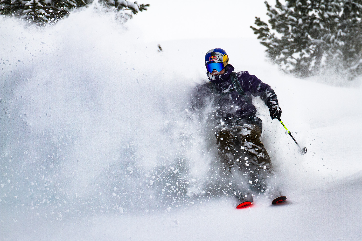 Man skiing through snow dust