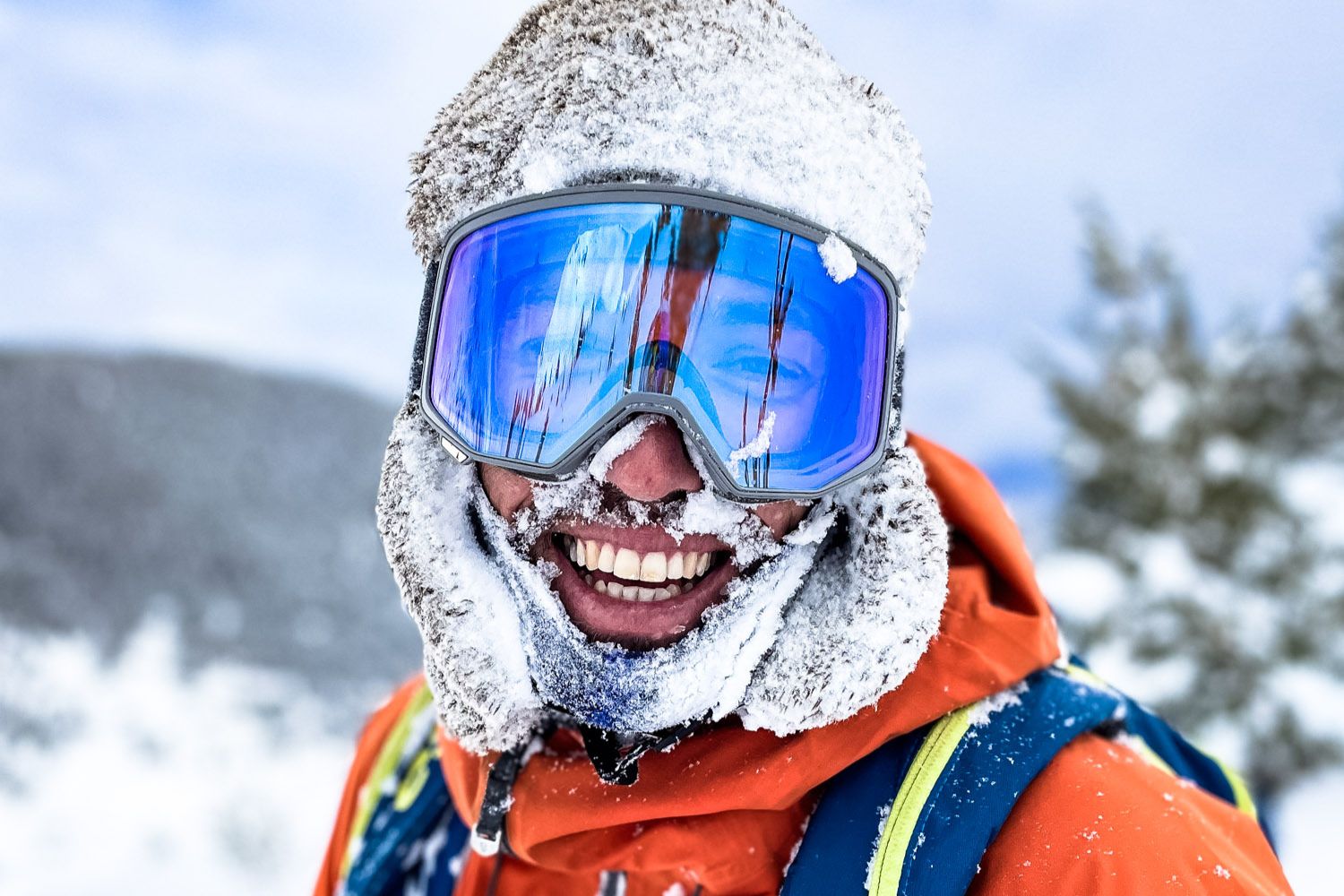 Man smiling covered in snow