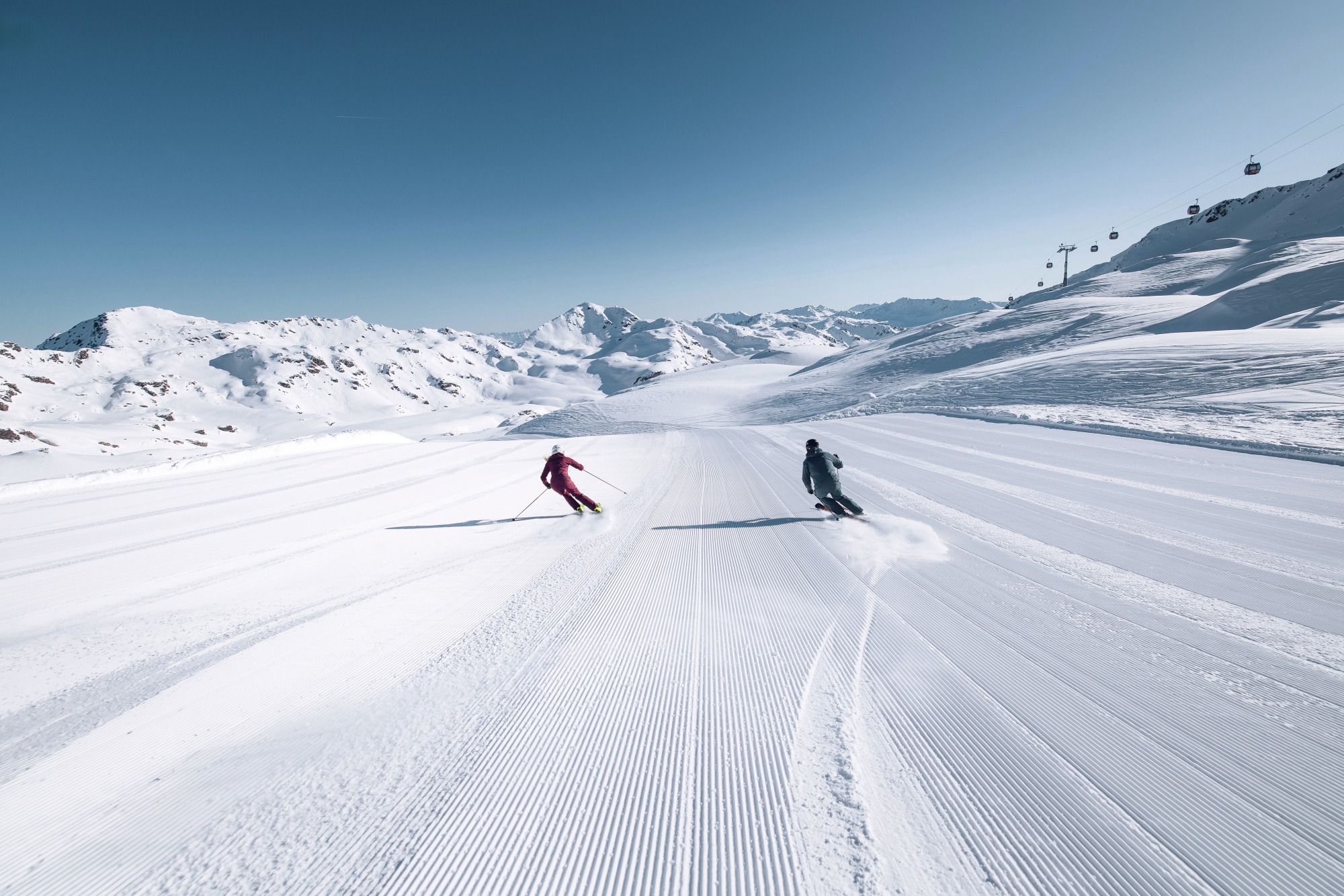 Skiers looking out over mountain landscape