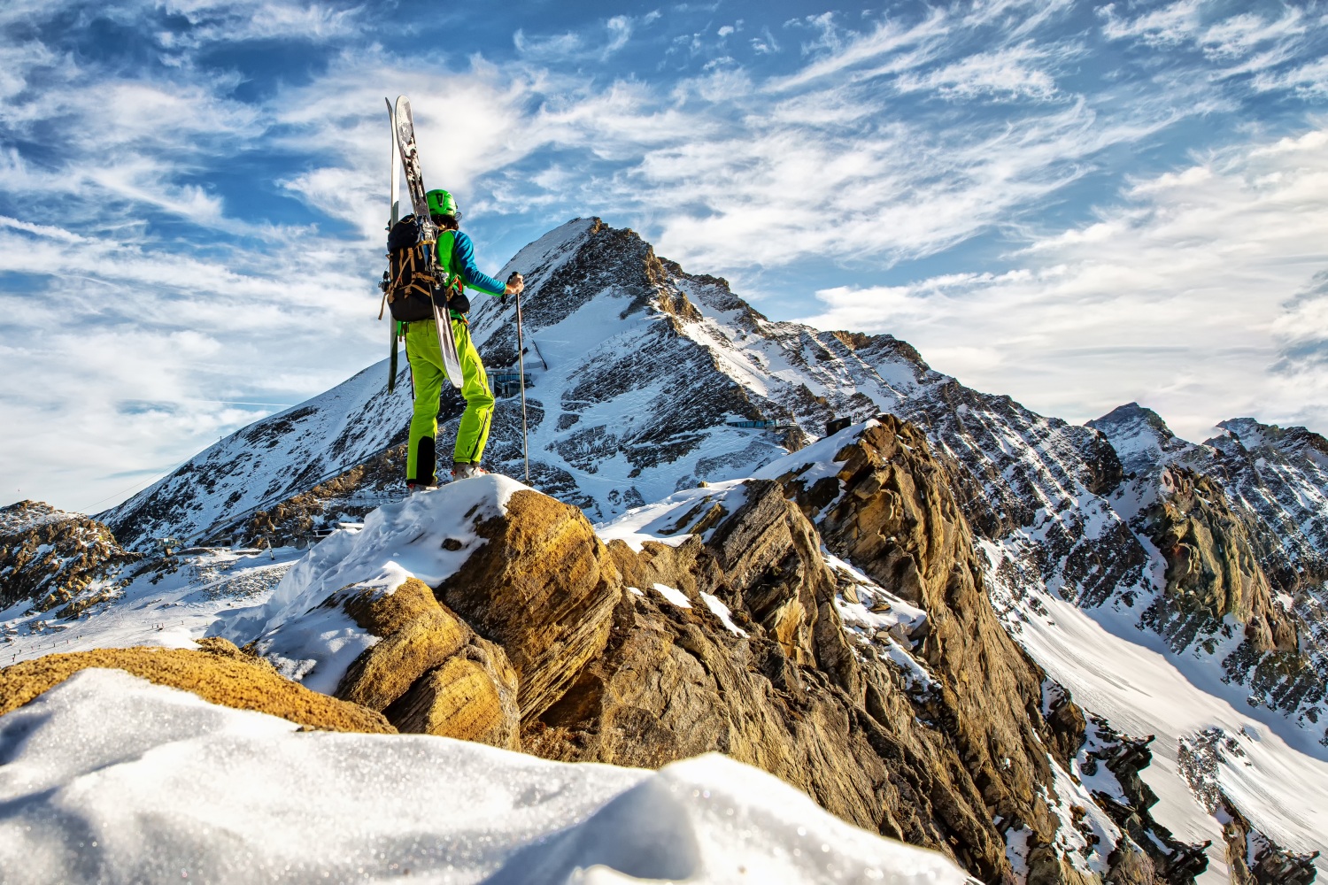Man stood on rocky mountain during ski touring