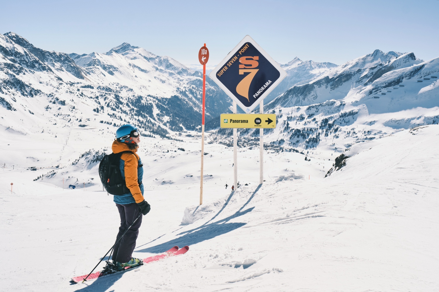 Skier next to sign in mountains