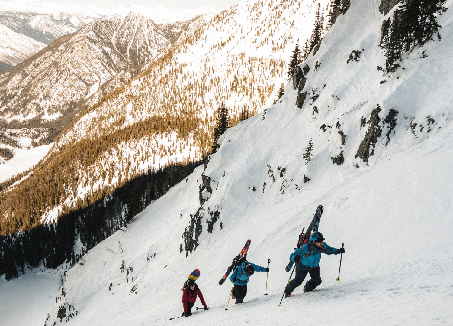 Skiers climbing up snowy mountain