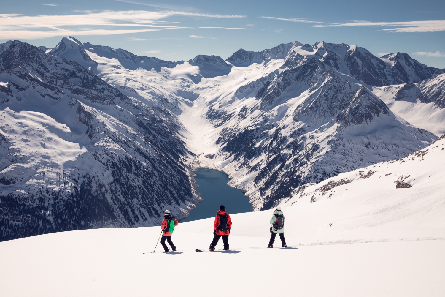 Skiers looking out over mountain landscape