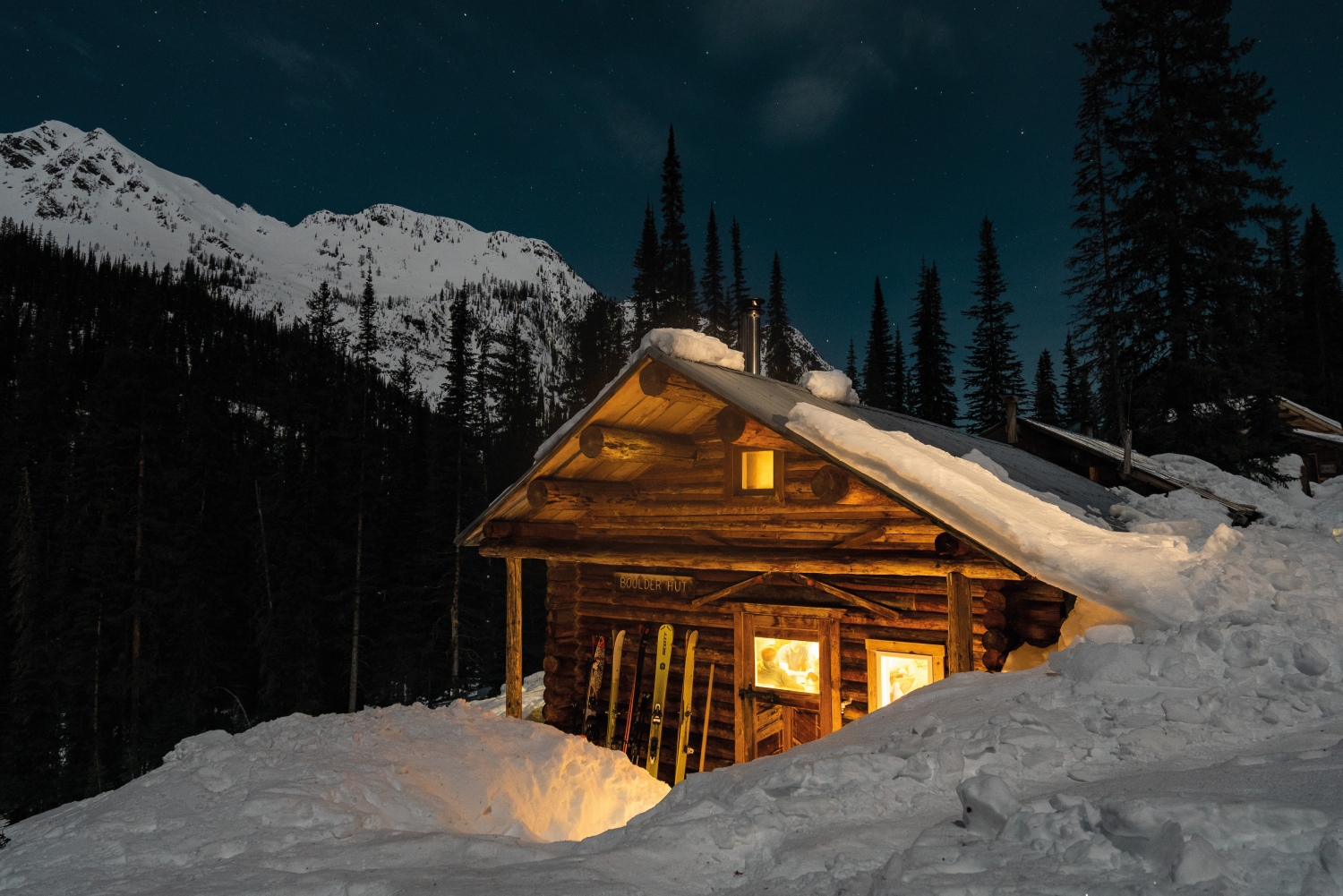 snowy cabin at night