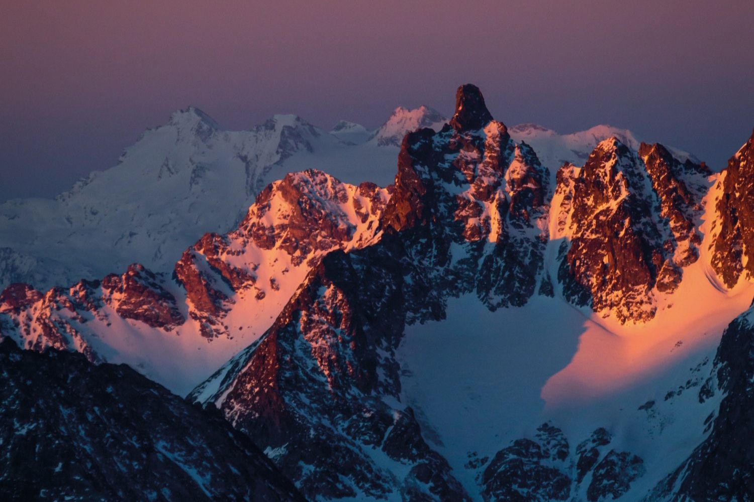 Sun rise or Sunset shining on snow covered mountain 