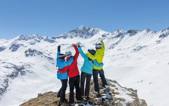 Group of skiiers cheering on mountain Meet in mountains CREDIT Crystal Ski Holidays