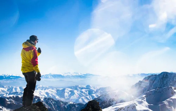 Man looking out over snowy mountains Kosovo CREDIT Tristan Kennedy