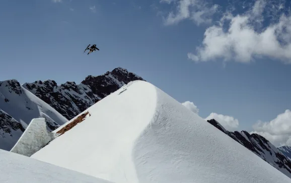 Skier jumping mid air from mound of snow Inside Track Dani Schiessl LOS 1451