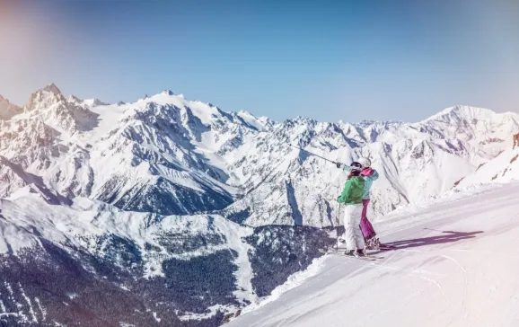 skiers looking out ober the beautiful swiss alps