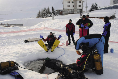 Kitting up to dive on Lake Tignes, France on the ice diving Tignes France