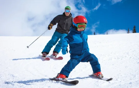 dad skiing with small child