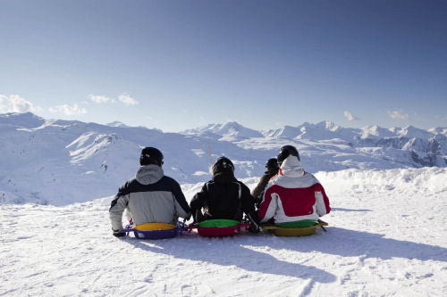 Resorts often offer more than just skiing for families Sledging with kids