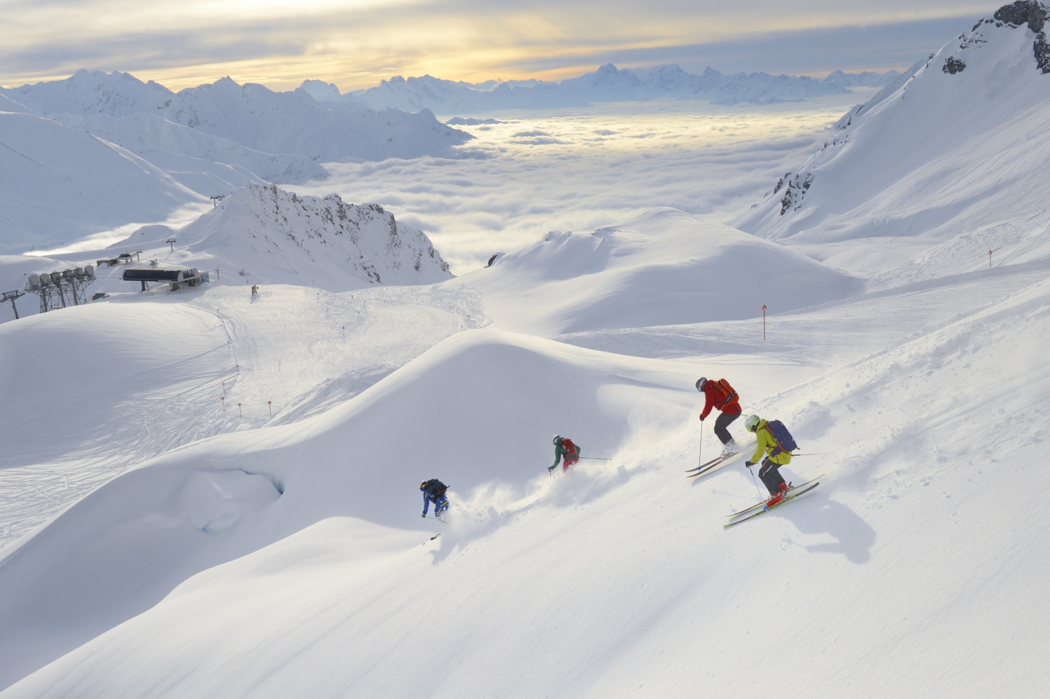 Group of people skiing down fresh snow in mountains - St Anton, Austria