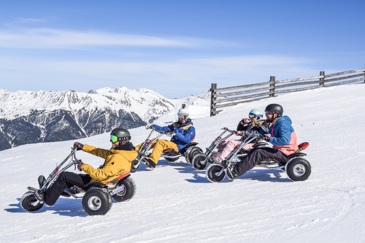 Group riding down slope on snow tricyles - Serre Chavelier, France
