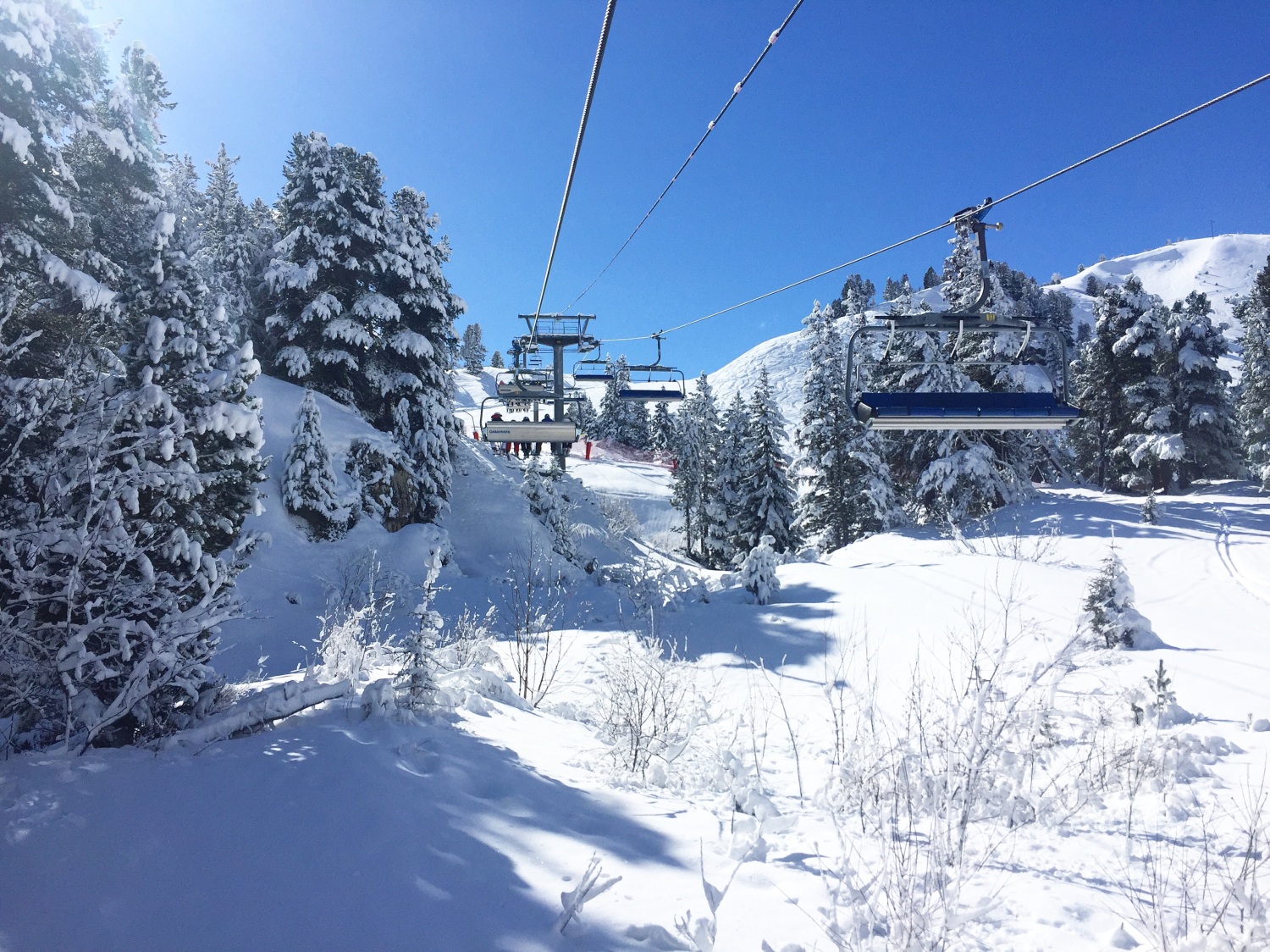 Ski lifts going across area with snow covered trees - Les Arcs, France