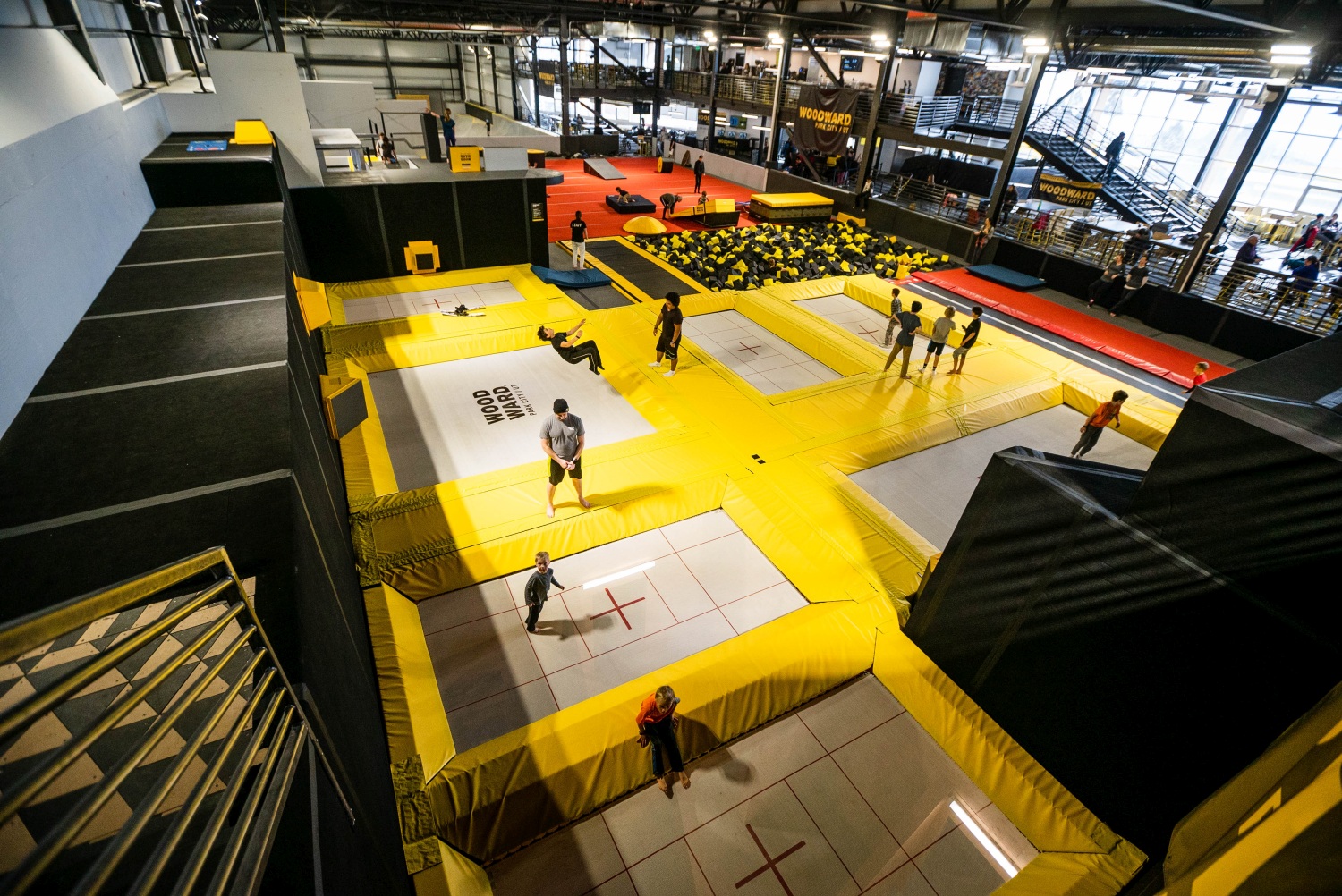 Kids and adults use the indoor trampoline park at Woodward Park City