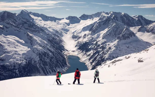 Skiers looking out over mountain landscape Skiing Zillertal Austria CREDIT Tom Klocker