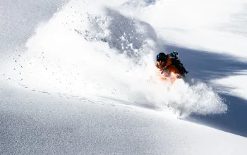 Man coming through large snow dust cloud Verbier CREDIT Tristan Kennedy